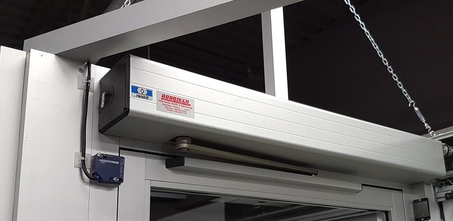Record automatic door operator installed above a commercial entrance